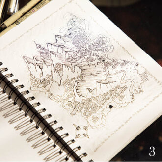 3.「空想の地図を書くのが好き」と市川さん。山並みと麓の村を繊細に表現。　